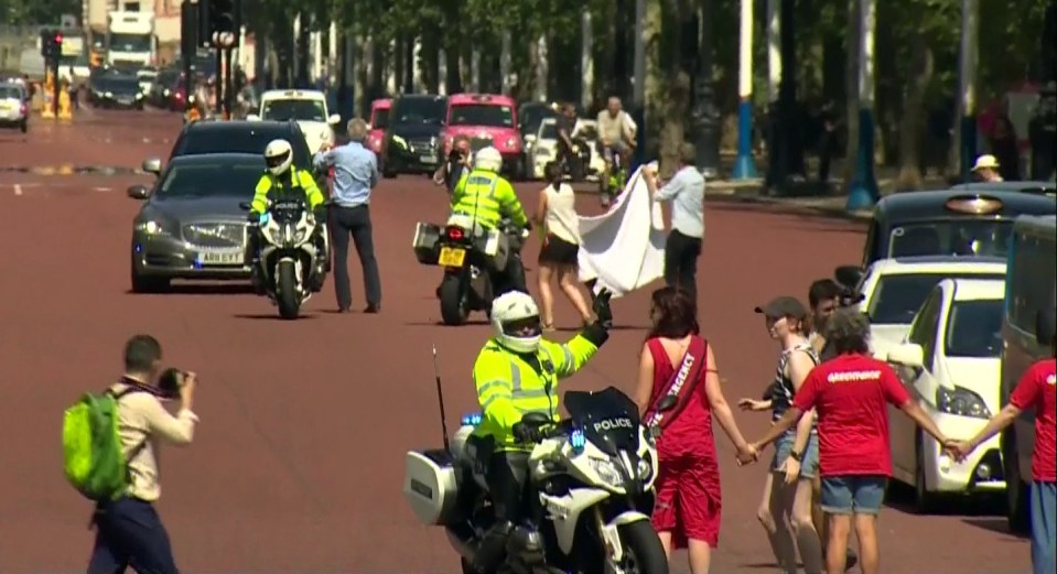  The activists were shoved out of the way by police officers