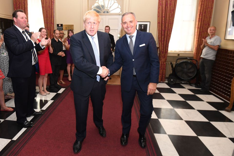  Mr Cummings, right, watches on as the new PM shakes hands with Cabinet Secretary Mark Sedwill