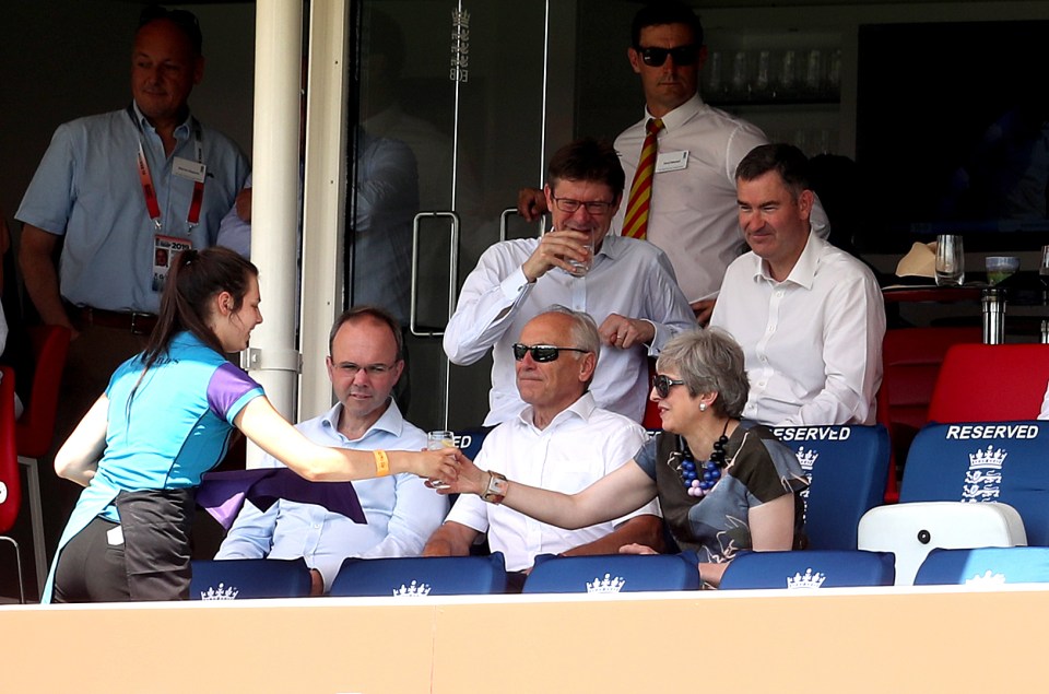  Mrs May looked relaxed and happy as a waiter handed her a drink