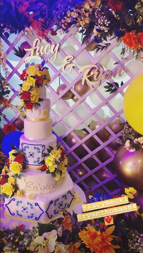  The cake was inspired by their time in the Amalfi coast, Italy, with yellow and red flowers cascading down and stunning blue tile patterns on every second tier