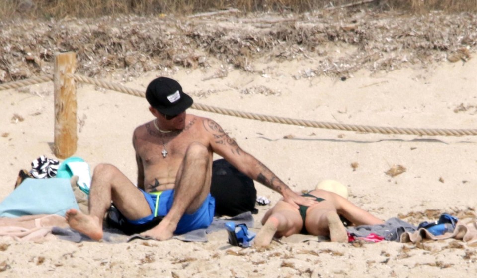  The loved up couple relaxed on the beach