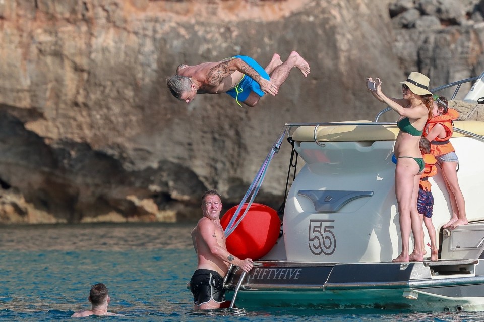  Robbie dived off the boat while on holiday with his family