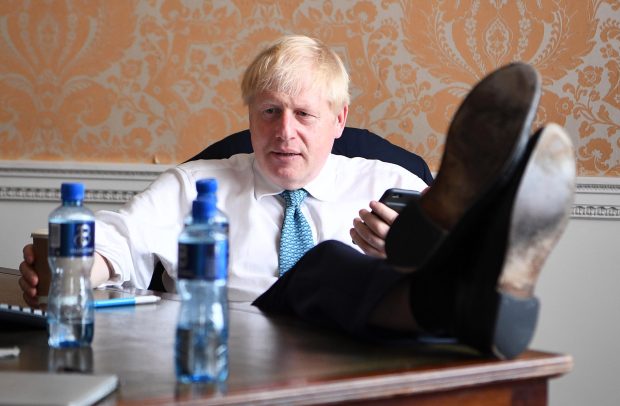 Boris Johnson sitting down a few minutes before leaving for the palace