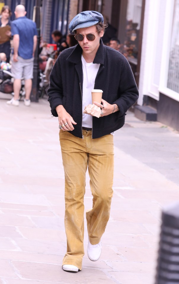  Harry Styles in camel corduroy flared trousers and a floppy baker boy cap