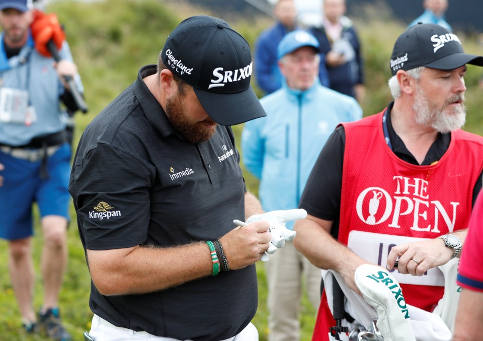  Lowry wrote 'sorry' on this glove and gave it to a fan after he hit him on the back with a wayward shot