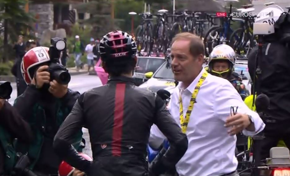  Race director Christian Prudhomme explains to defending champ Geraint Thomas why the racing has been cancelled for the day