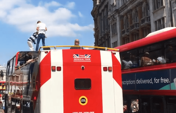 Two men were seen clambering onto the top of a tourist bus during the Robinson protests