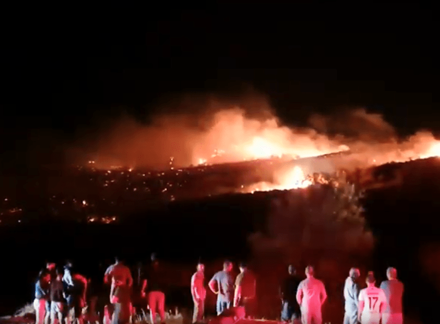  Flames light up the night sky where the missile came down