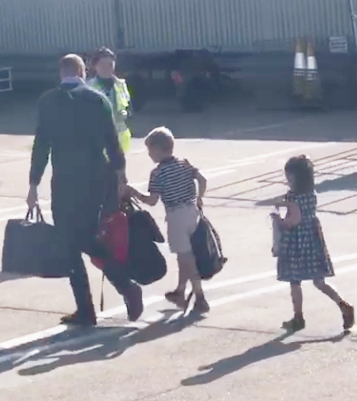  William holds his own bags as he walks with Charlotte and George