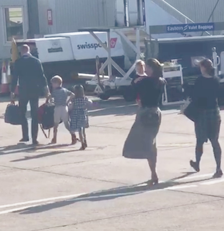  Kate and Wills walk across the runway with their own bags and children after flying on a FlyBe plane