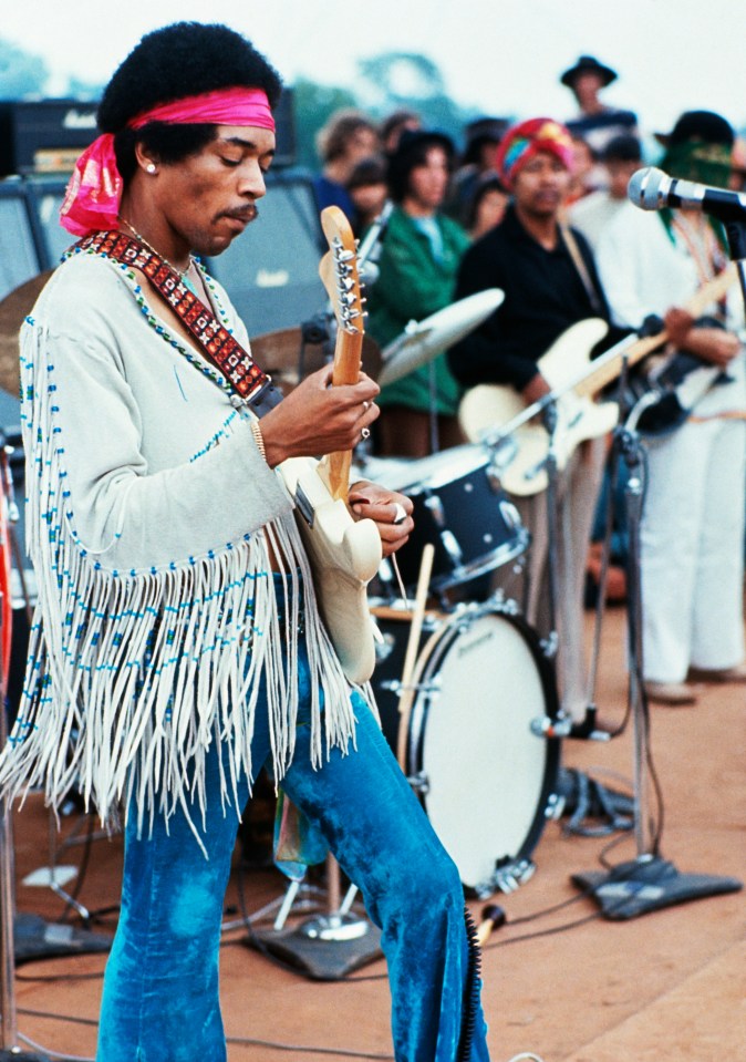  Music icon Jimi Hendrix playing his guitar during his set at the Woodstock Music and Art Fair, 1969