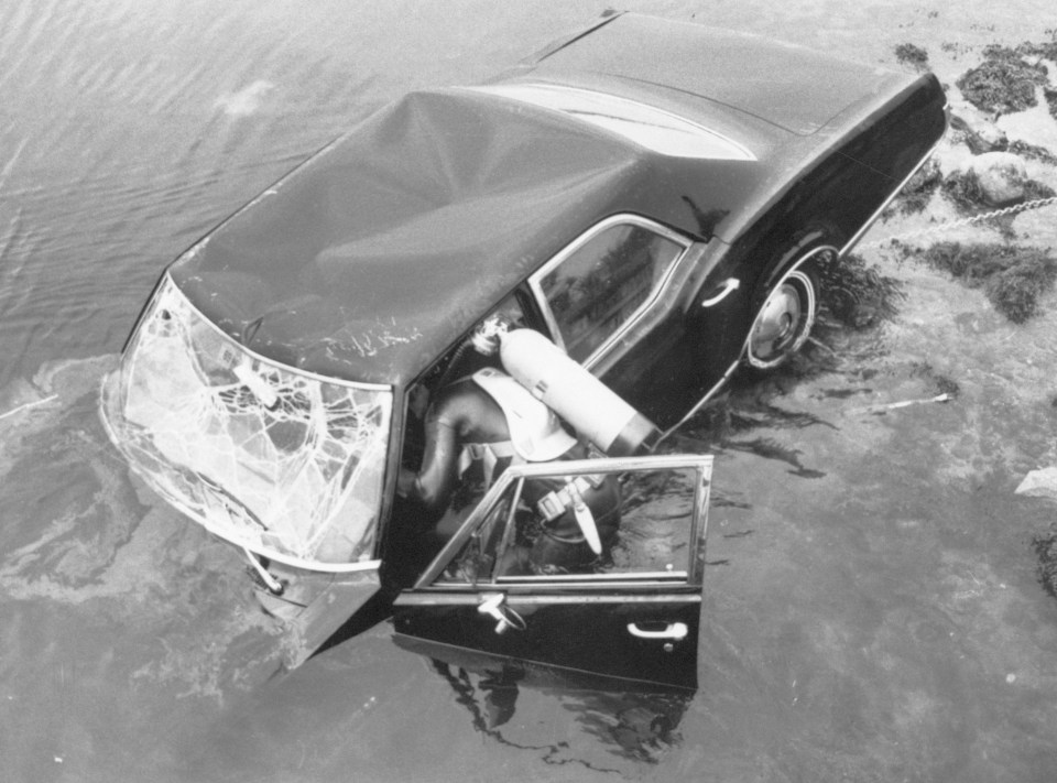  A frogman attempts to raise Edward Kennedy's car eight hours after it plunged into pond 