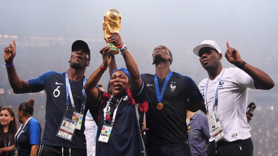 Paul Pogba's mum Yeo Moriba lifts the World Cup trophy last summer with her sons