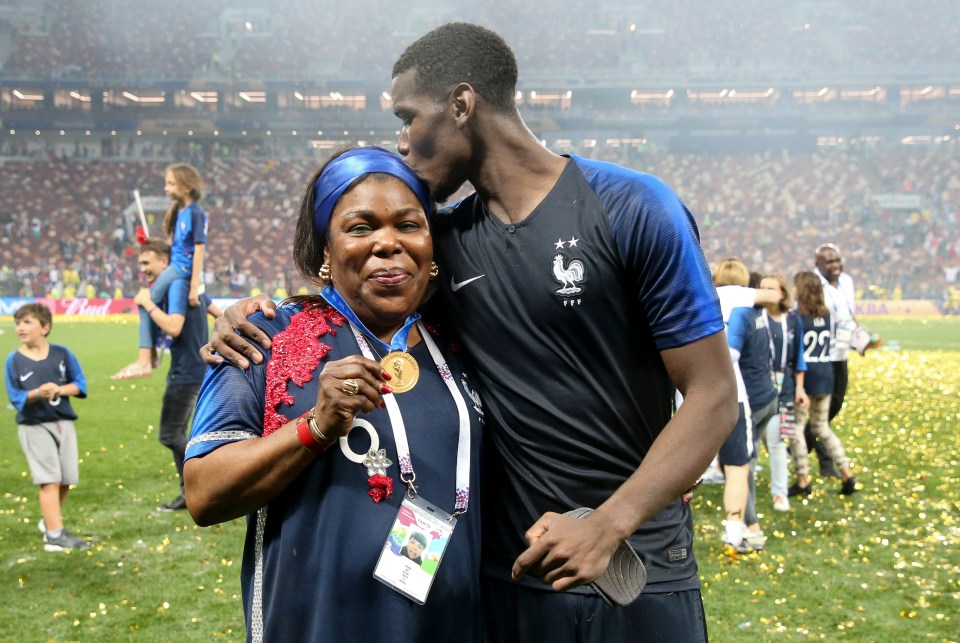 Pogba embraces his mother Yeo Moriba after winning the World Cup with France last summer