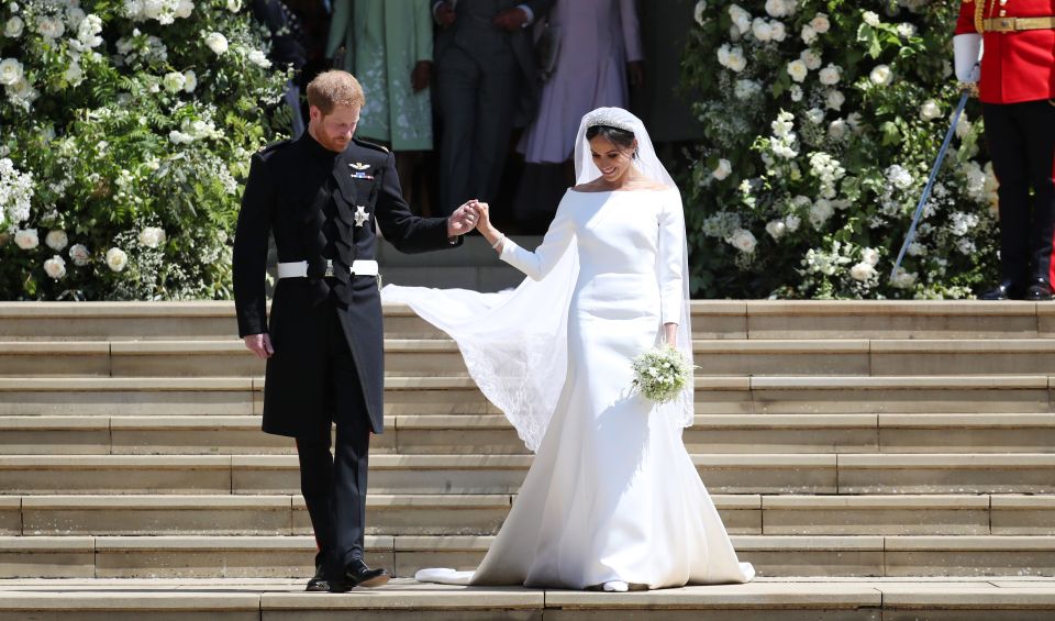  Prince Harry and his royal bride Meghan Markle at at steps of St George's Chapel, Windsor Castle on May 19, 2018