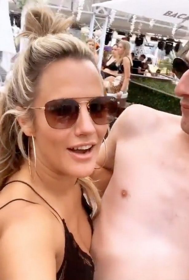  Caroline Flack cosied up to a bare chested man at a pool party after the Love Island final