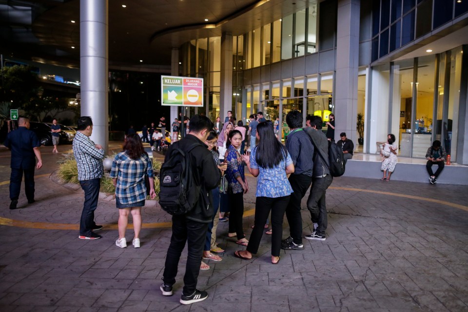  Residents stand outside of high rise building following a 7 -magnitude earthquake in Indonesia