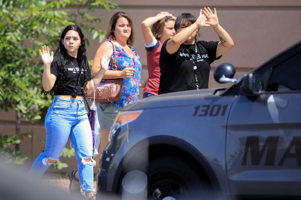  Shoppers exit with their hands up after a sickening mass shooting in El Paso, Texas