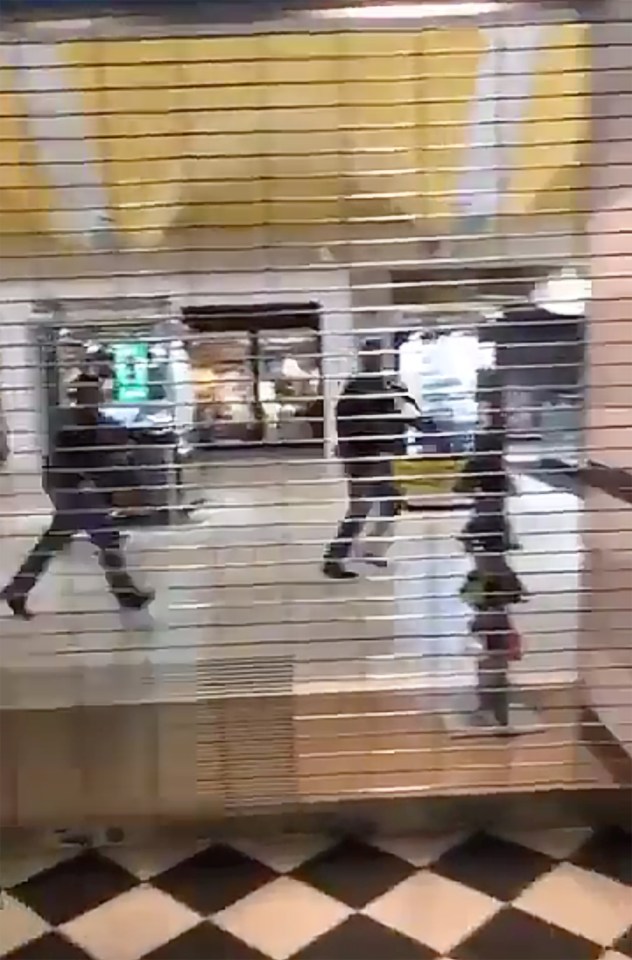  Police officers are seen rushing through the Cielo Vista Mall after an active shooter entered the store and opened fire