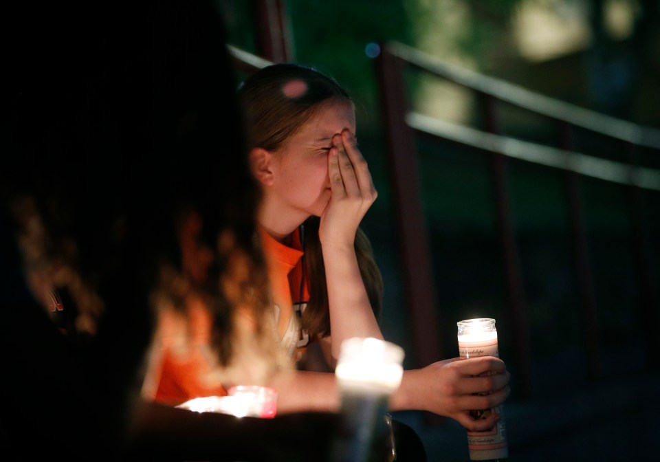  Sherie Gramlich reacts during a vigil for victims of the mass shooting