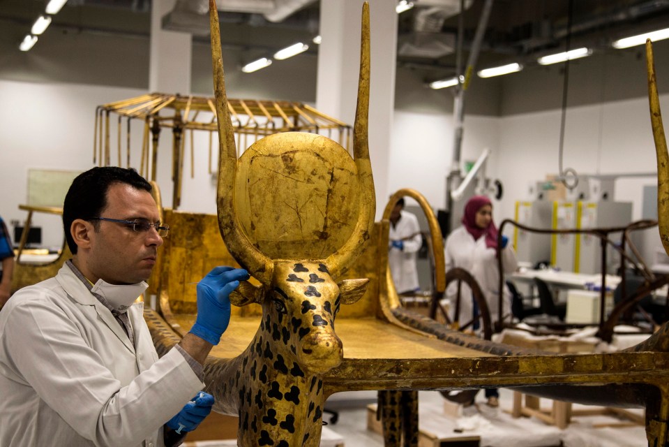  Egyptian archeologists work on funerary beds belonging to King Tutankhamun