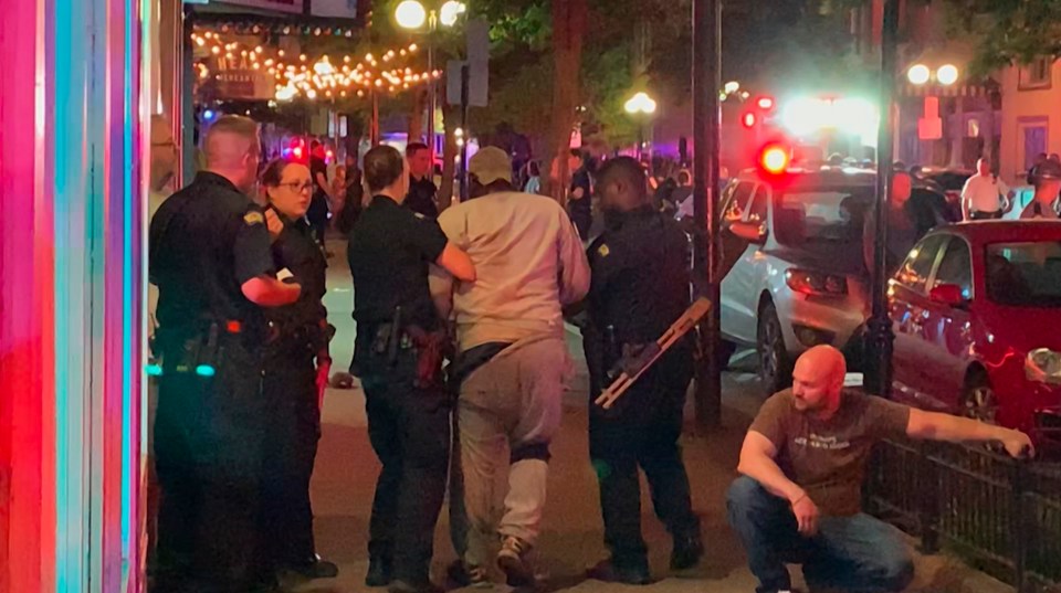  Police helping a wounded victim in the aftermath of Sunday's shooting spree