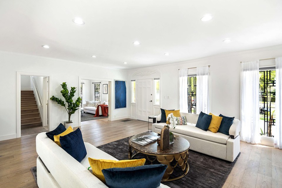 The light-filled living room opens to a dining room and family room