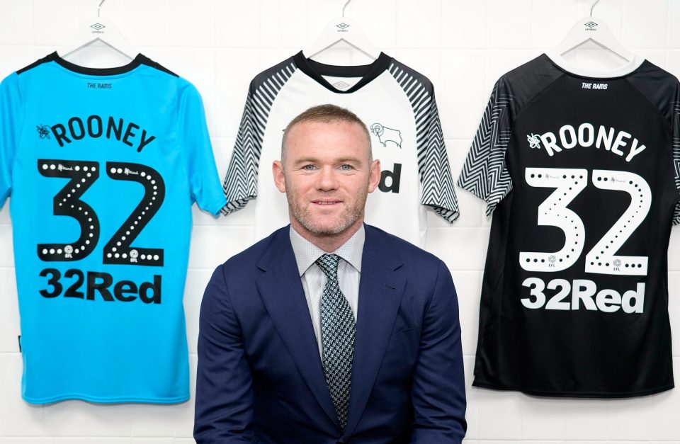  Rooney poses with No32 shirts after completing move to Derby