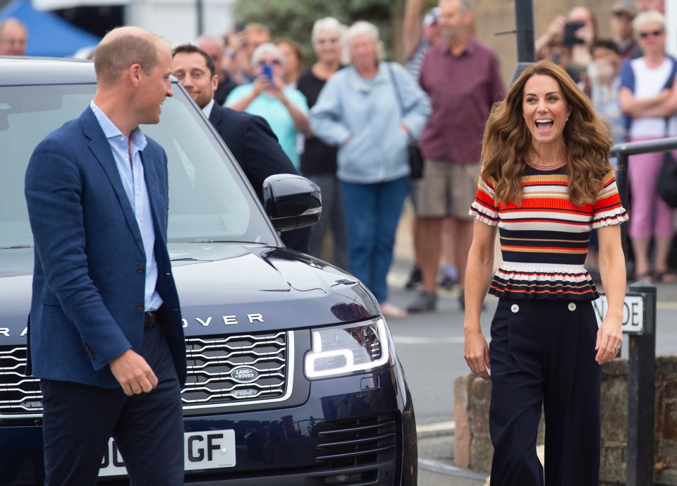  Donning nautical stripes, Kate giggled as she prepared to take William on for the Royal Regatta