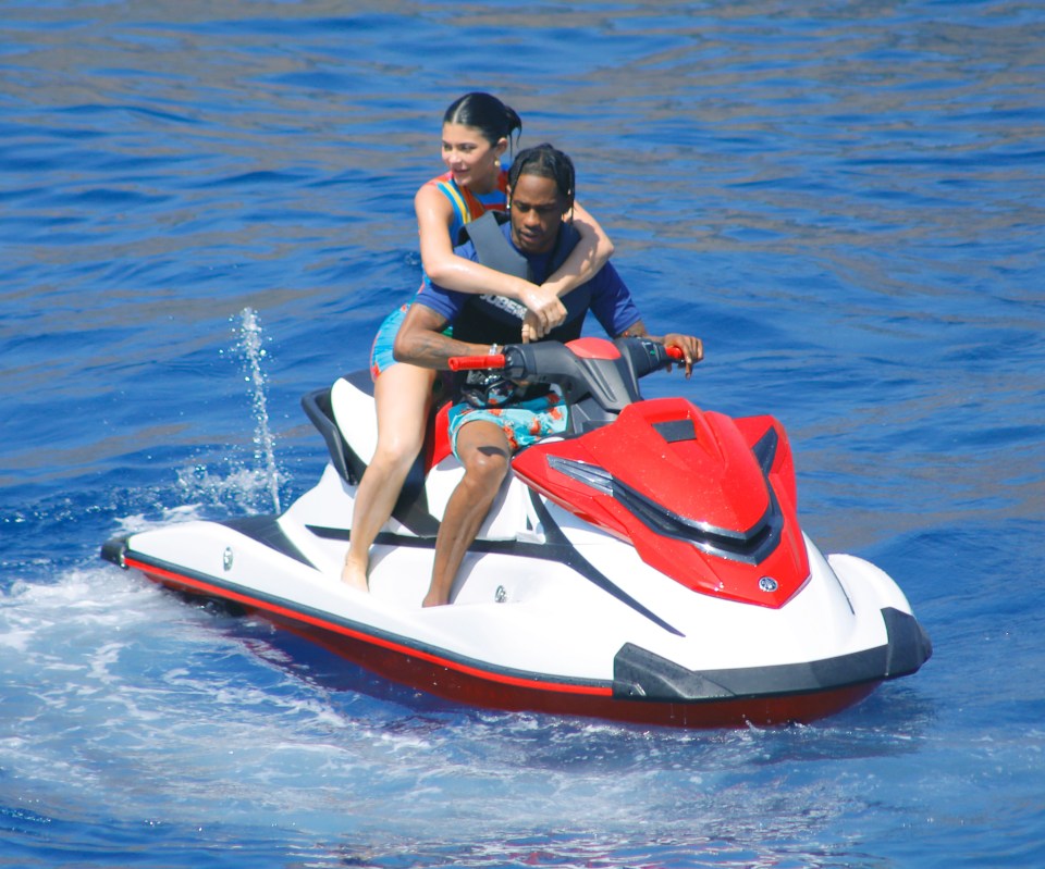 Kylie  riding a jetski with Travis