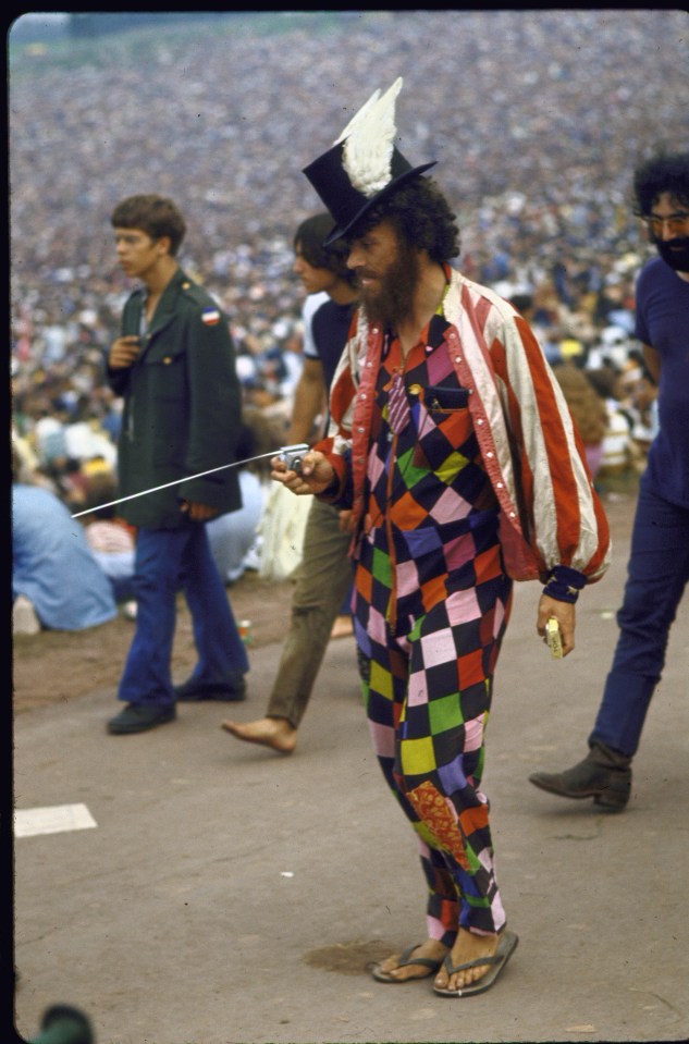  Paul Foster, wearing a top hat with wings, a multi-coloured outfit and a red and white striped jacket, at the Woodstock festival