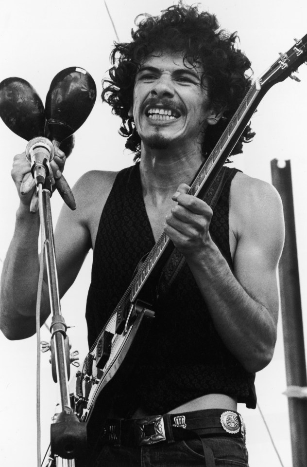  Mexican-born American guitarist and bandleader Carlos Santana holds maracas and an electric guitar while performing at Woodstock, 50 years ago