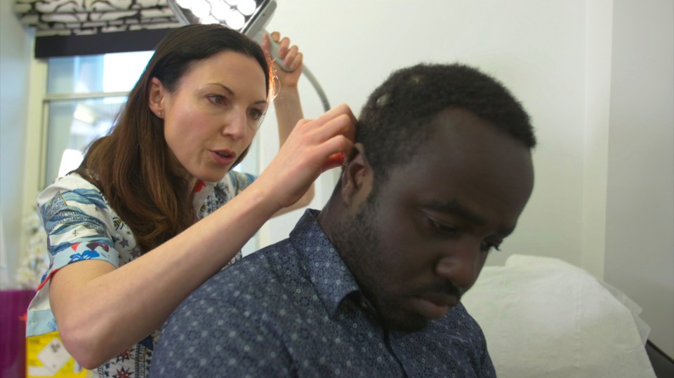  Andrew Mensah in the clinic with Dr Emma Craythorne as she takes a look at the lump on the back of his head