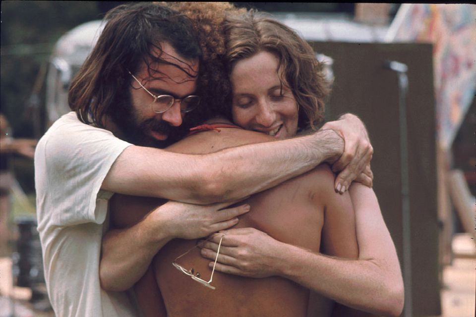  Three men attending the Woodstock music festival hug each other. The festival was documented in the 1970 film “Woodstock,” which won an Oscar