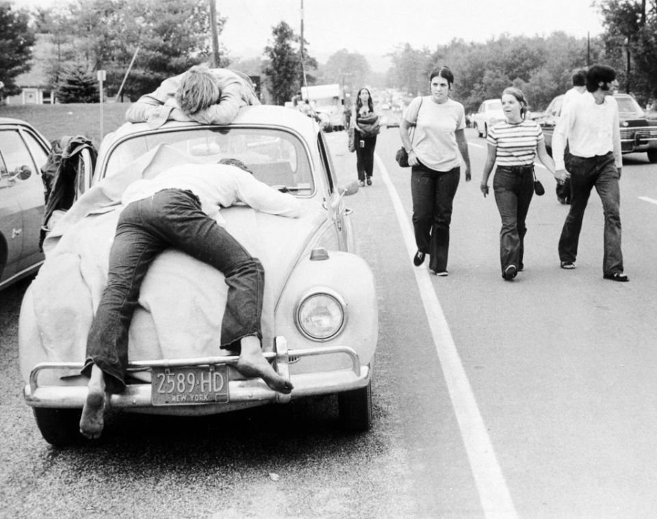  Two festivalgoers who found Woodstock too much passed out on the bonnet and roof of their Volkswagen Beetle