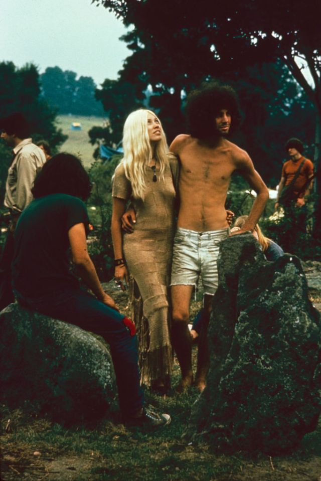  A couple stand together, arms around one another at Woodstock