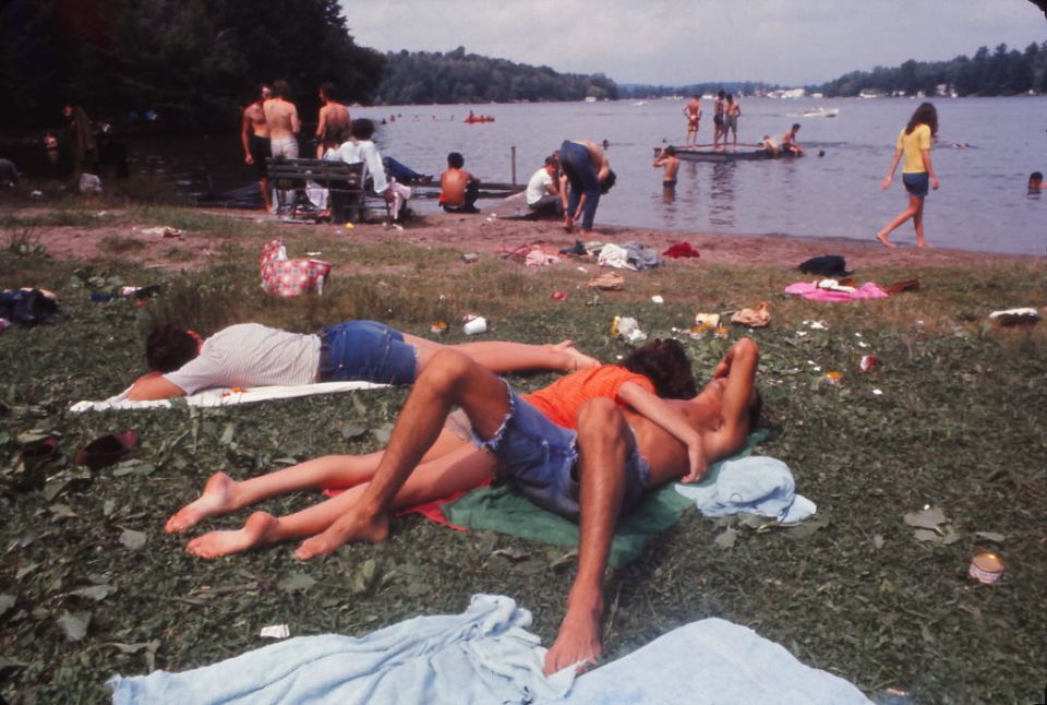  Young people relaxing by a lake at Woodstock - some Americans saw the event as an outrageous display of indulgence at a time of war