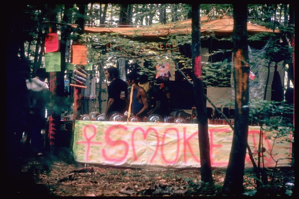  Paraphernalia stand in the woods featuring pillows, posters, and incense