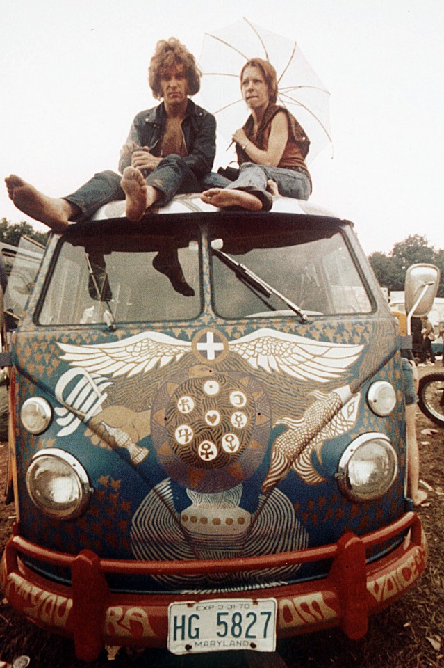  Concertgoers sit on the roof of a Volkswagen bus at Woodstock, mid-August, 1969. The three-day concert became a landmark cultural event of the late '60s