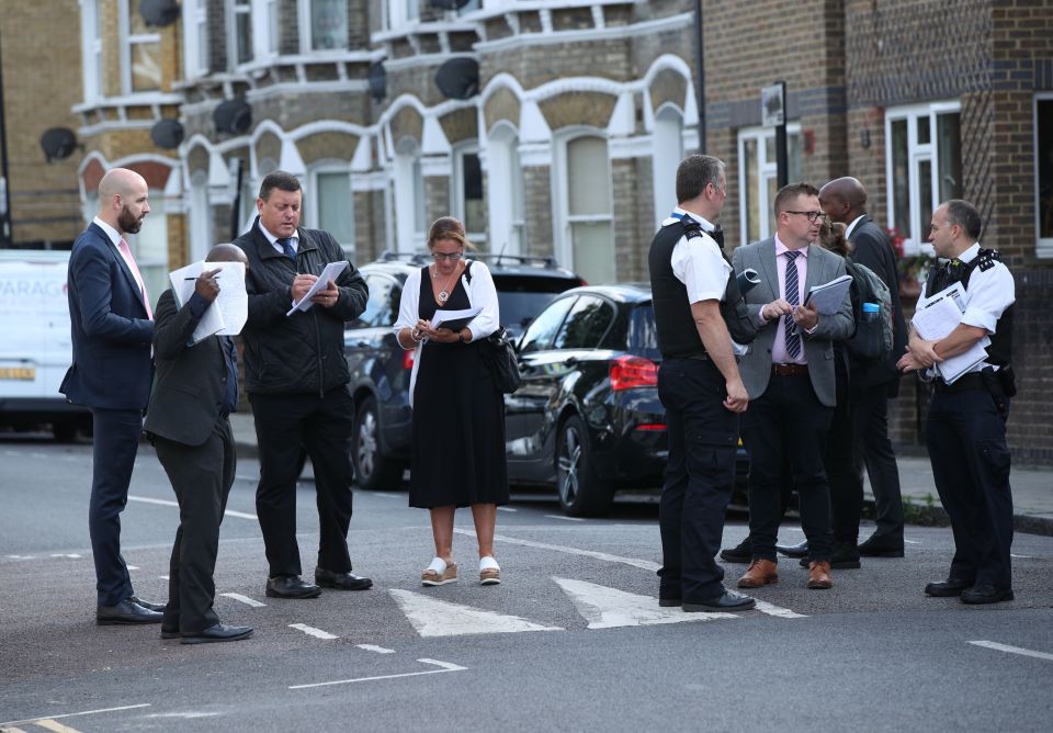  Police officers at the scene of a fatal stabbing in Corrance Road, Lambeth