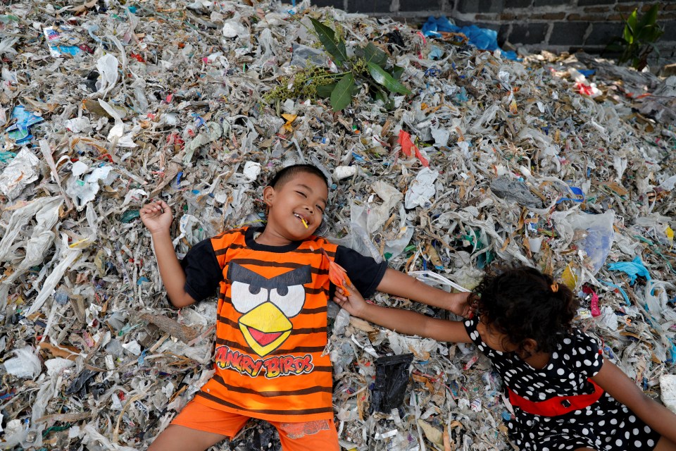  Kids play on pile of rubbish at Bangun village in Mojokerto, East Java province