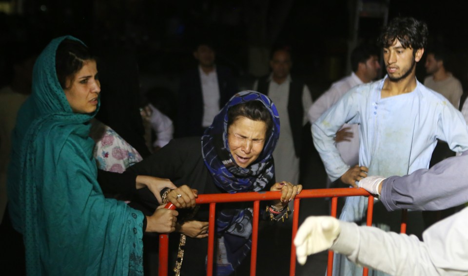 A grieving woman wails outside the hospital where the wounded were taken