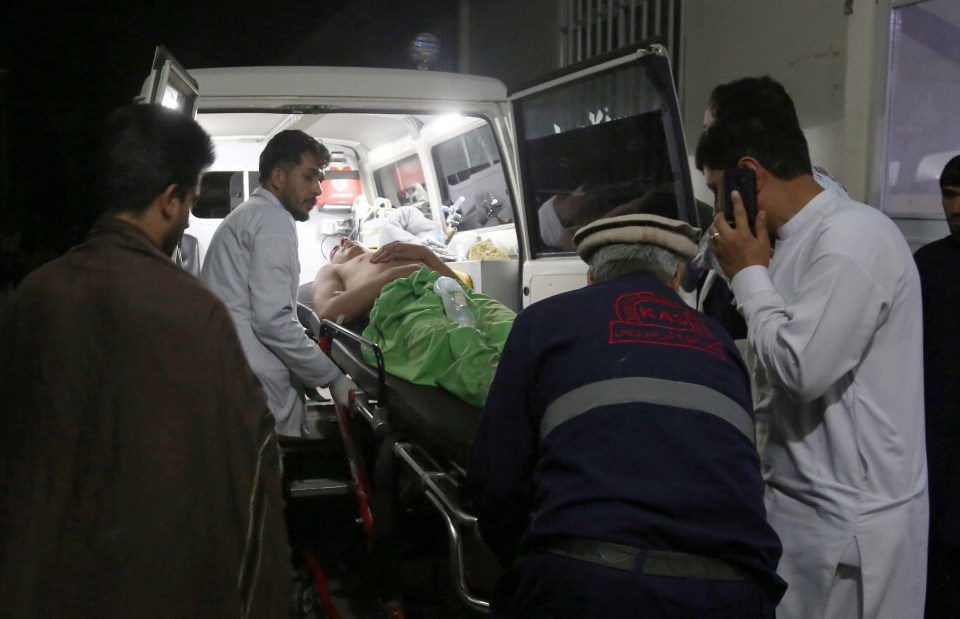 Paramedics wheeling a victim into an ambulance in the aftermath of the bomb blast