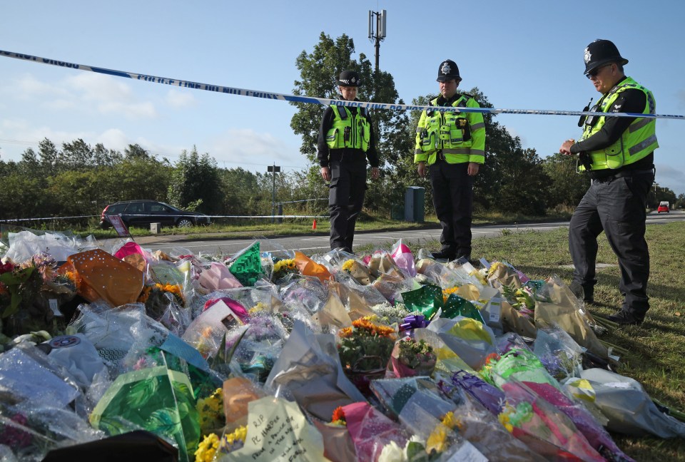 Wellwishers have placed dozens of floral tributes to PC Harper at the junction where he was killed