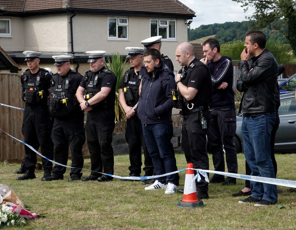 Fellow police officers line up to remember their fallen colleague today