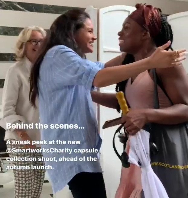 A smiling Meghan hugs women as they arrive for the photoshoot