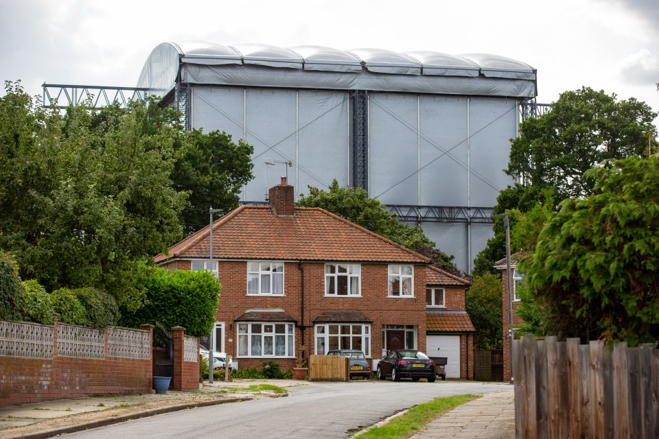  The back of the stage looms over a row of houses