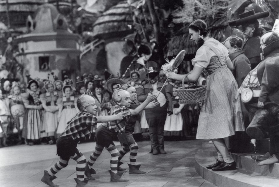  Munchkins giving Garland a lollipop in the film