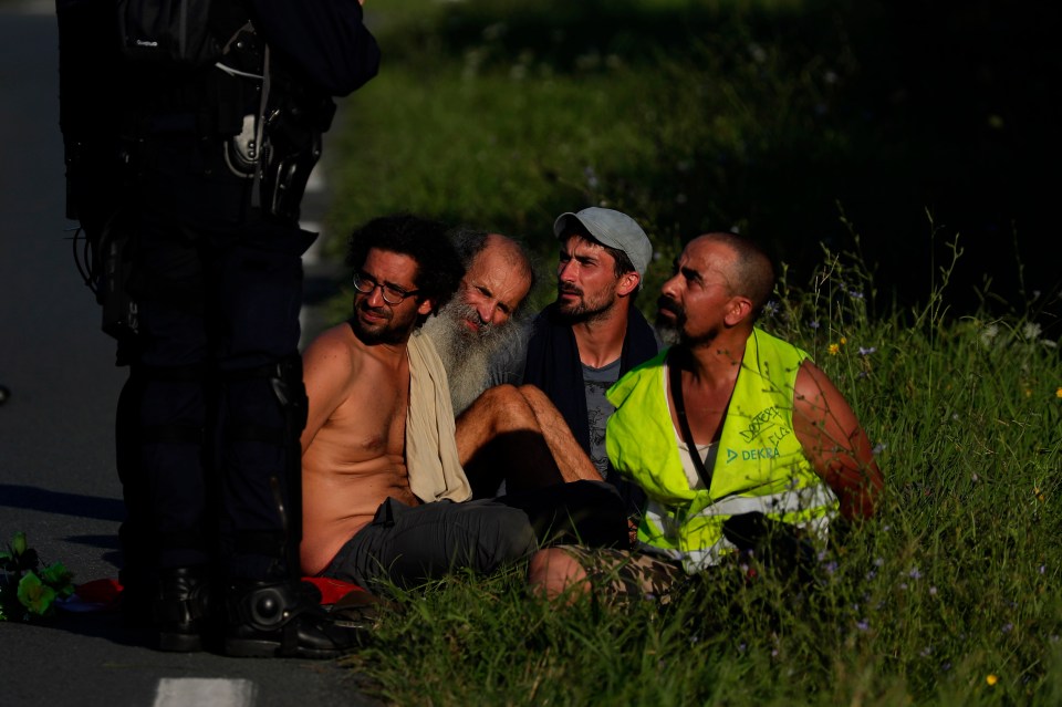  Protesters are detained as they marched along a road towards the summit site