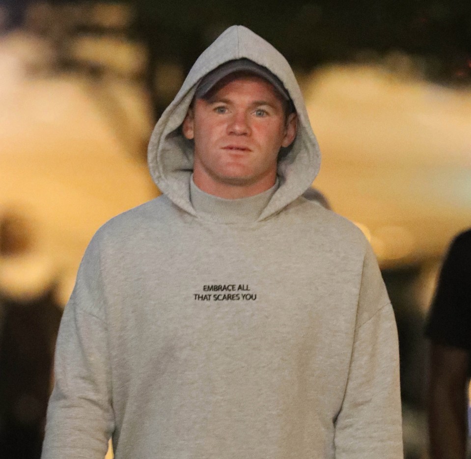 Wayne is pictured earlier on the night out with fellow players, wearing the distinctive hoodie and cap